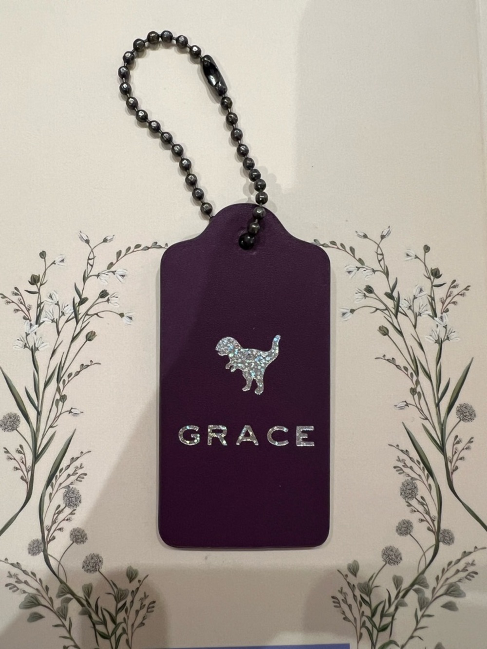 Coach Purple Tag Keychain with Holographic T-Rex Dinosaur “Grace” Monogram NEW